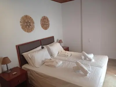 a bedroom with a bed with towels on it at Tassos Holiday home in Archangelos