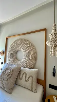 a headboard of a bed with a wickerigun at Centro Blu Luxury Apartment in Rhodes Town