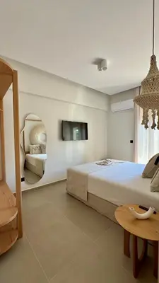 a bedroom with a bed and a tv on the wall at Centro Blu Luxury Apartment in Rhodes Town
