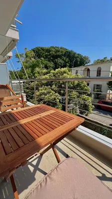 a wooden bench sitting on top of a balcony at Centro Blu Luxury Apartment in Rhodes Town