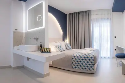 a bedroom with a bed with a sink and a mirror at MelMar Aegean Harmony in Faliraki