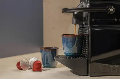 a coffee maker with two cups on a counter at MelMar Aegean Harmony in Faliraki