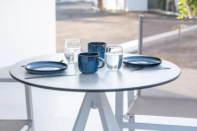 a white table with plates and glasses on it at MelMar Aegean Harmony in Faliraki