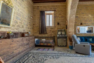 a living room with a couch and a television at Finieli's Rustico in Malona Village