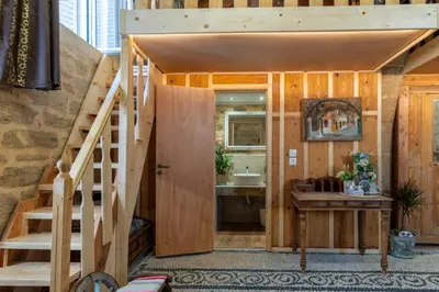 a tiny house with a staircase leading to a bathroom at Finieli's Rustico in Malona Village
