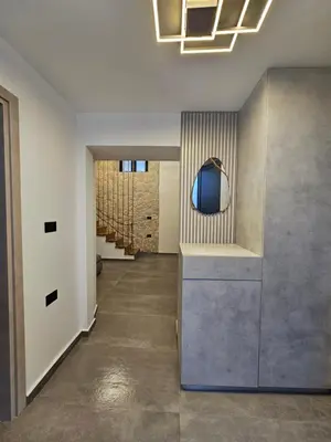a hallway of a house with a mirror and stairs at A&A Niohori Home in Rhodes Town