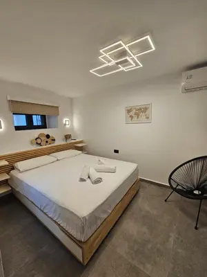 a bedroom with a large bed in a room at A&A Niohori Home in Rhodes Town