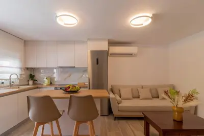 a kitchen and living room with a couch and a table at Christina's Apartment in Afantou