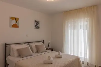 a bedroom with a bed with two towels on it at Christina's Apartment in Afantou
