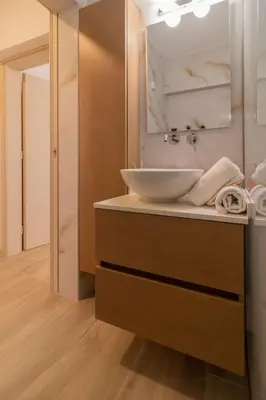 a bathroom with a sink and a mirror at Christina's Apartment in Afantou