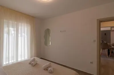 a bedroom with a bed with two towels on it at Christina's Apartment in Afantou