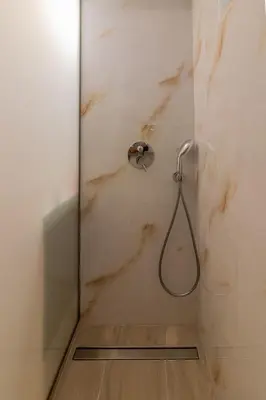 a shower with a hose in a bathroom at Christina's Apartment in Afantou