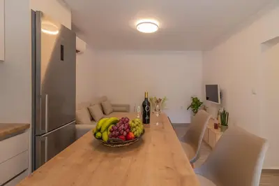 a bowl of fruit on a wooden table in a kitchen at Christina's Apartment in Afantou
