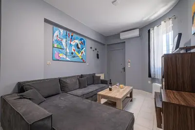 a living room with a couch and a table at Kounaki Wines Central Square Apartments in Émbonas