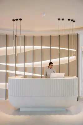 a man standing at a desk with a laptop at Cento Palme in Rhodes Town