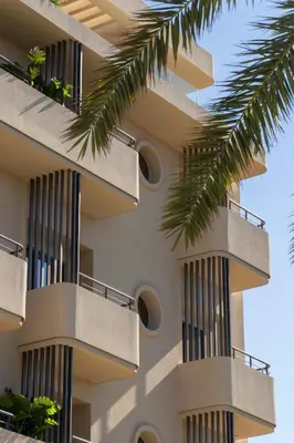 a building with balconies and palm trees at Cento Palme in Rhodes Town