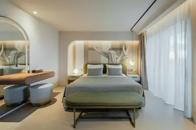 a bedroom with a bed and a large window at Cento Palme in Rhodes Town