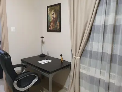 a desk with a chair next to a curtain at Yiannis Sokaki House in Rhodes Town