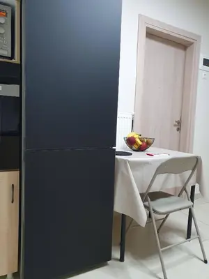 a black refrigerator in a kitchen with a table at Yiannis Sokaki House in Rhodes Town