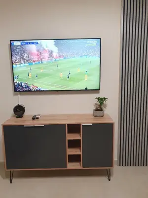 a flat screen tv on a wall in a living room at Yiannis Sokaki House in Rhodes Town