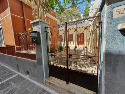 a gate on the side of a building at Yiannis Sokaki House in Rhodes Town