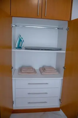 a closet with white drawers and towels in it at ELMA apartment 1 Kremasti in Kremasti