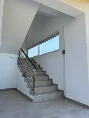 a staircase in a house with a window at ELMA apartment 1 Kremasti in Kremasti