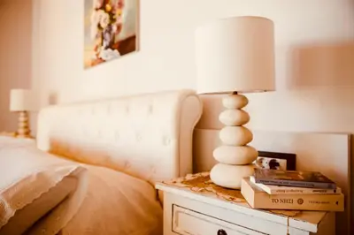 a bedroom with a bed and a lamp on a dresser at Estrella Villas in Lardos