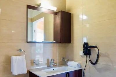 a bathroom with a sink and a mirror at Estrella Villas in Lardos
