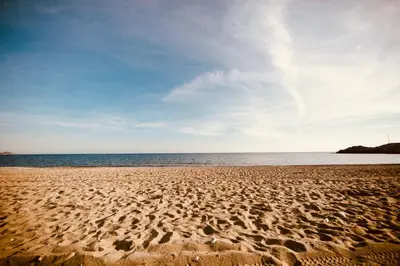 a sandy beach with a view of the ocean at Estrella Villas in Lardos