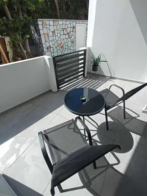 a patio with a table and chairs on a balcony at Nirea Studio II in Faliraki