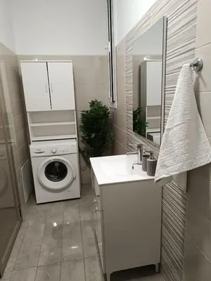 a bathroom with a washing machine and a sink at Tatti's Apartment in Rhodes Town