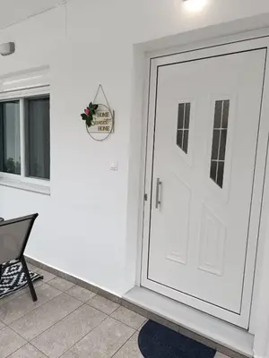 a white door in a room with a chair at Tatti's Apartment in Rhodes Town