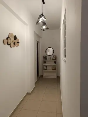 a hallway with white walls and a ceiling at Tatti's Apartment in Rhodes Town