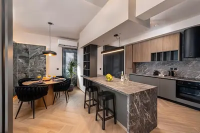 an open kitchen with a large island with bar stools at Dolce Casa Suite2 in Afantou
