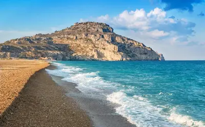 a beach with a mountain in the background at Dolce Casa Suite2 in Afantou