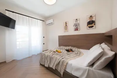a bedroom with a large bed with a wooden headboard at Dolce Casa Suite2 in Afantou