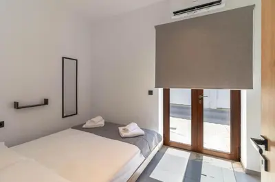 a bedroom with a bed and a window at Antonis Traditional House in Afantou