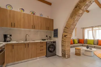 a kitchen with a washer and dryer in a room at Antonis Traditional House in Afantou