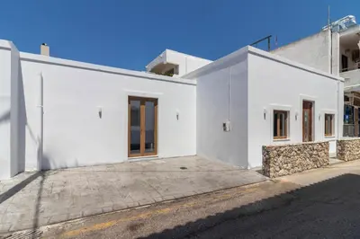 a white house on a street at Antonis Traditional House in Afantou