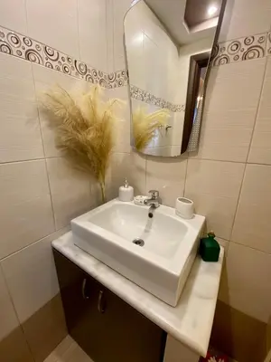 a bathroom with a white sink and a mirror at Villa Moné in Koskinou