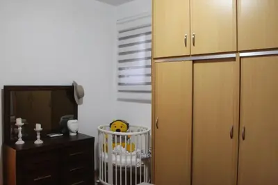 a room with a dresser and a cabinet and a crib at Villa Moné in Koskinou