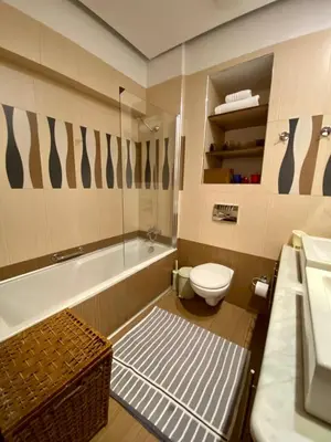 a bathroom with a tub and a toilet and a sink at Villa Moné in Koskinou