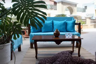 a blue couch and a coffee table in a living room at Villa Moné in Koskinou