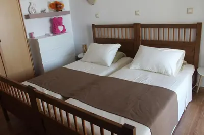 a bedroom with two beds with white sheets and pillows at Villa Moné in Koskinou