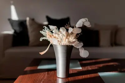 a silver vase with flowers on a table at Villa Panagiota, Pefkos in Pefki Rhodes
