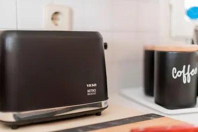 a toaster sitting on a counter next to a cup of coffee at Villa Panagiota, Pefkos in Pefki Rhodes