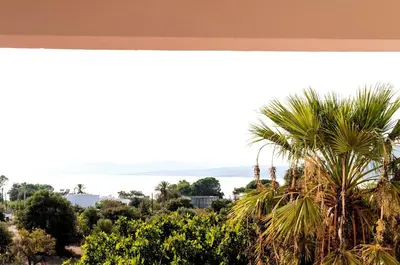 a view of the ocean from a resort with palm trees at Villa Panagiota, Pefkos in Pefki Rhodes