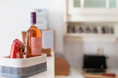 a bottle of wine in a container on a counter at Villa Panagiota, Pefkos in Pefki Rhodes