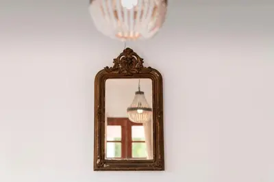 a mirror hanging on a wall with a chandelier at Villa Panagiota, Pefkos in Pefki Rhodes
